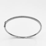 Oval cubic zirconia claw set sterling silver rhodium plated hinged bangle