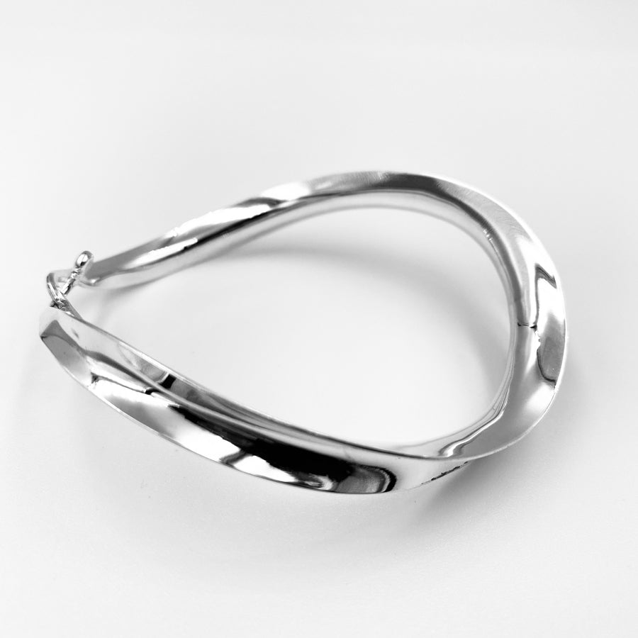 Twist flexible sterling silver concaved bangle